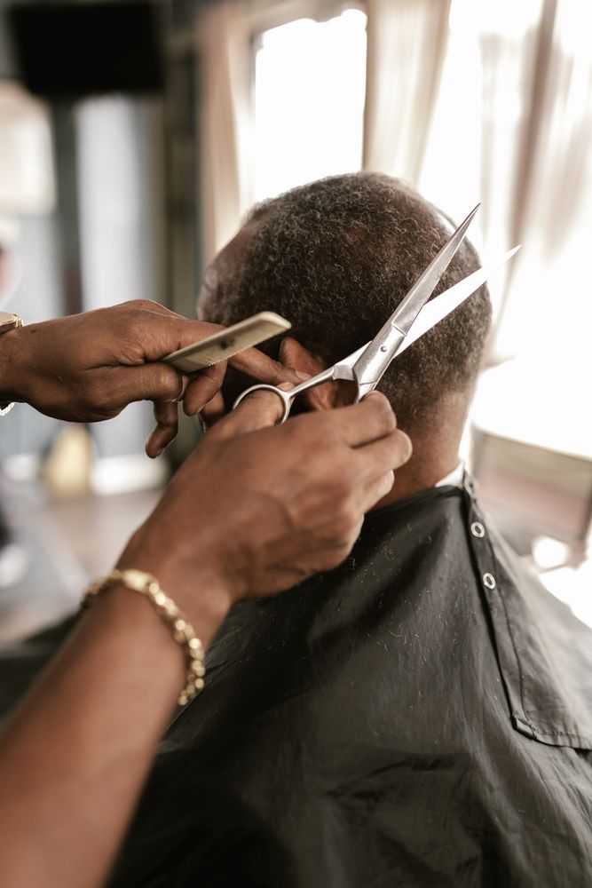 Back view of Black man getting a haircut at the barber shop