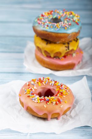 Delicious assorted colorful donuts on the table.
