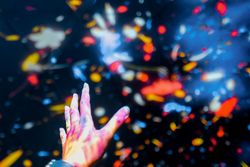Hand reaching into light projections