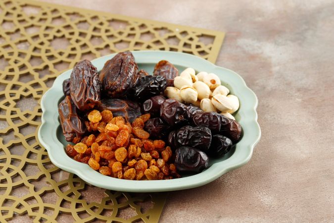 Plate of dried fruit and nuts on patterned placemat