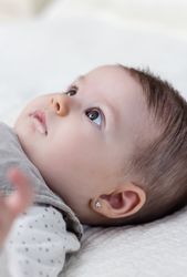 Happy baby girl lying on back