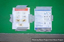 Sign taped to wall at testing site with instructions on how to remove gloves safely 4d8vD4