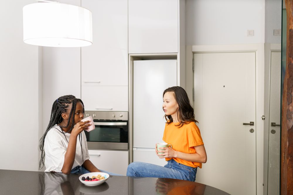Two women chatting over breakfast in the kitchen