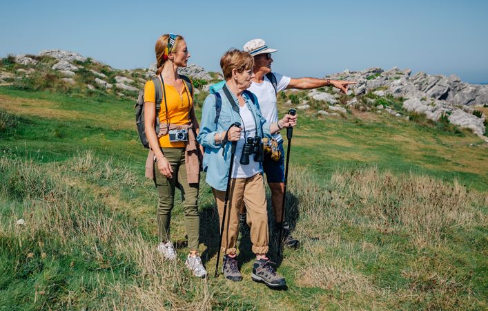 Mature adults hiking with their daughter on clear day