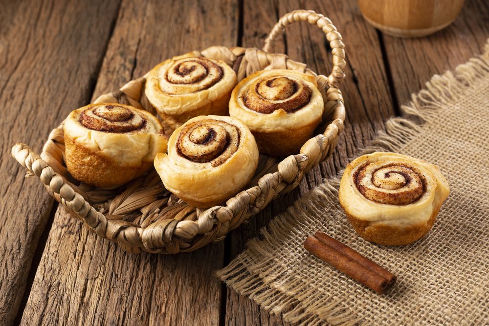 Cinnamon rolls on wooden background.