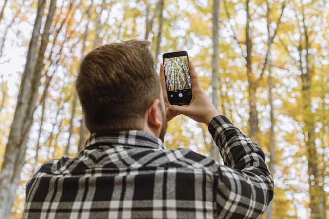 Casual tourist making photo on smartphone of nature