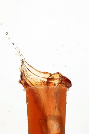 Low Angle Splash of Iced Tea on Plastic Cup