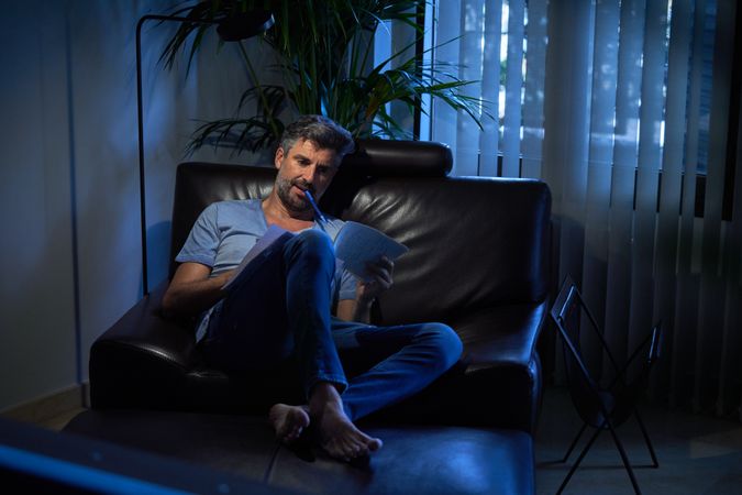 Office worker doing paperwork in dark room