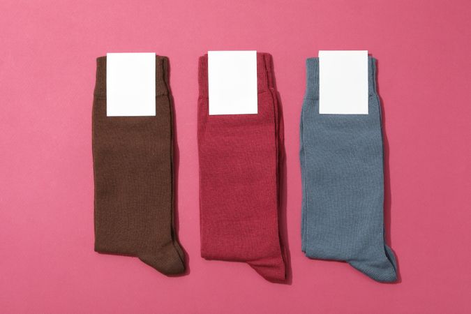 Multicolored high socks on a pink background.