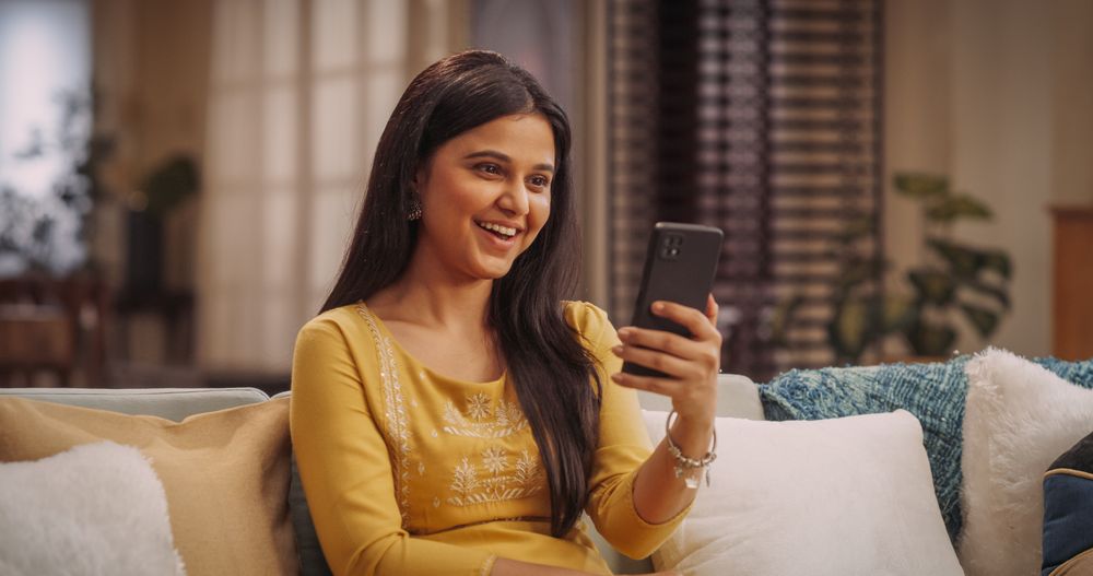 Portrait of Gorgeous Indian Woman on a Smartphone Video Call from Home: Talking to Girlfriends, or Connecting with Family.