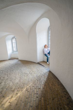 Relaxed woman resting in window sill