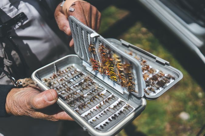 Fisherman demonstrating collection of baiting in box