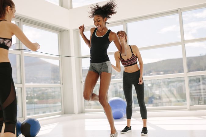 Females enjoying jumping rope workout at gym
