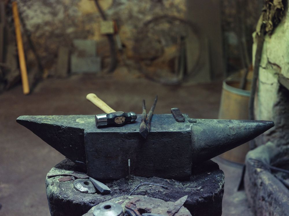 Anvil with hammer and tongs in forge