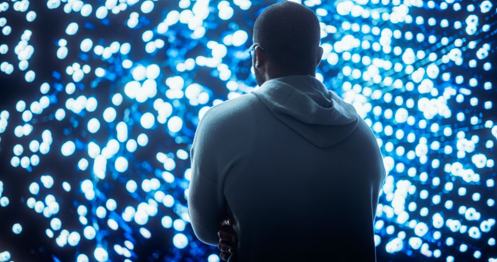 Black Young Man Looking at Big Screen with Neural Network Visualisation In 3D.
