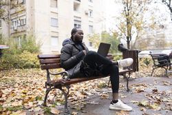 Wireless connectivity enabling digital communication for a man on a bench.