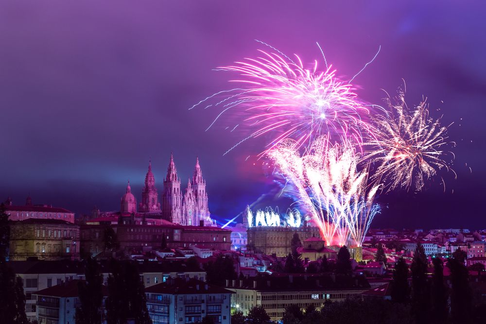 Fireworks above towers of castle in European city at night