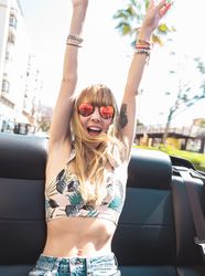 Young woman riding cabriolet