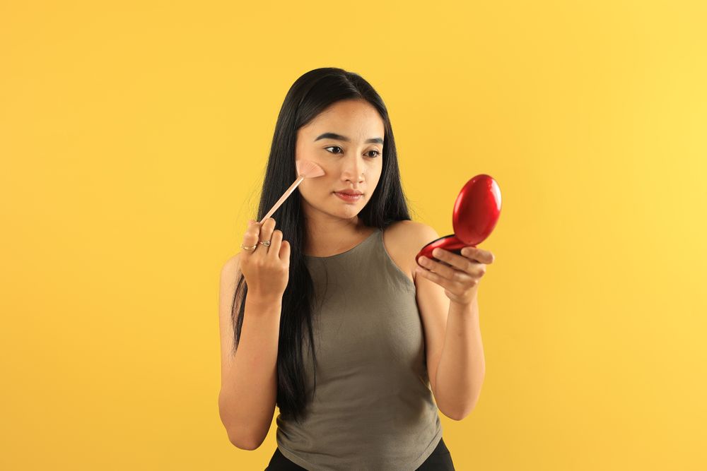 Young Indpnesian Asian Long Hair Woman Holding Brush and Mirror, Aplying Make Up