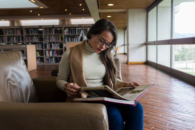 Woman in glasses reading a book