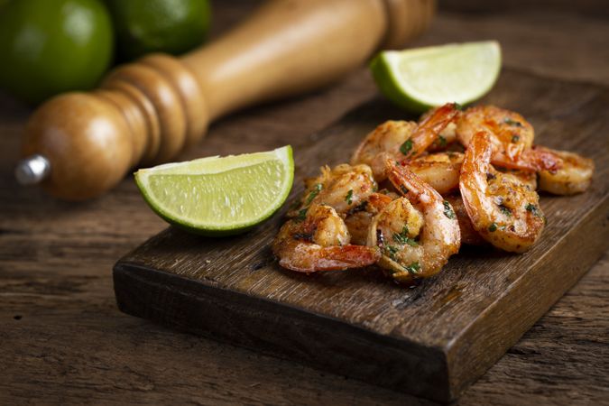 Delicious grilled prawns on wooden background.