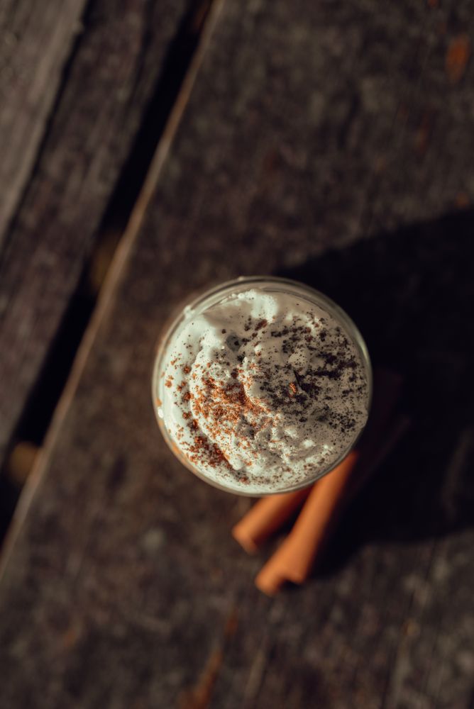 Cinnamon near coffee on table