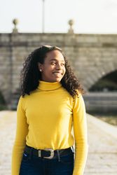 Black woman standing in front of a bridge