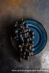Plate of red grapes on navy plate 4d8BpD