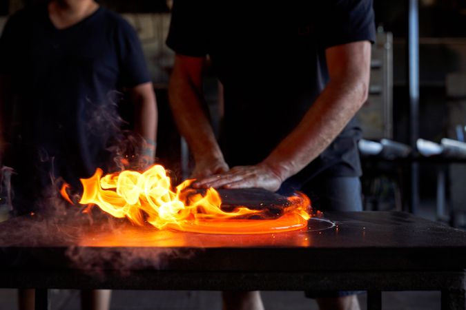 Crop craftsmen working at glassblowing factory