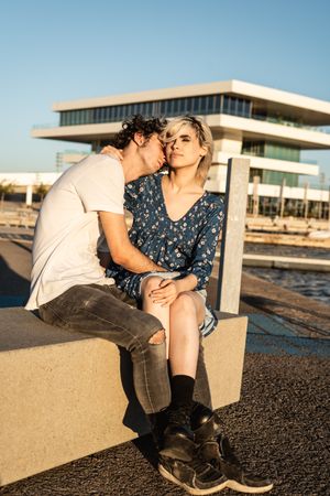 Loving couple cuddling with pleasure on waterfront