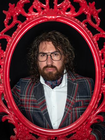 Portrait of imposing man in red art frame