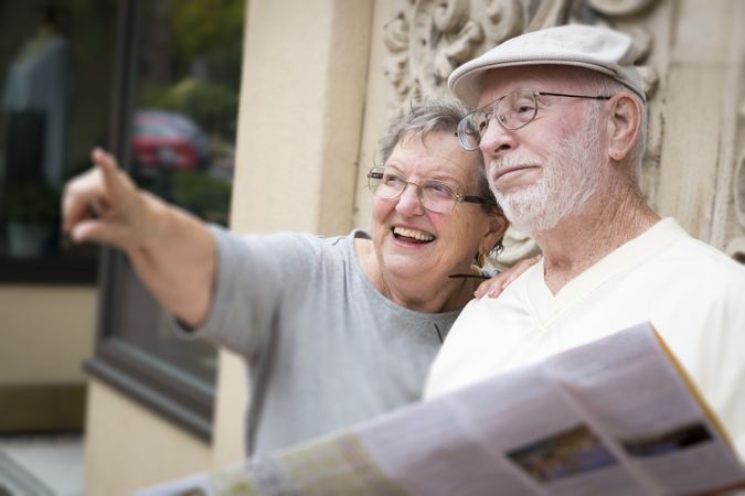 Tourist Couple Looking at Brochure Map