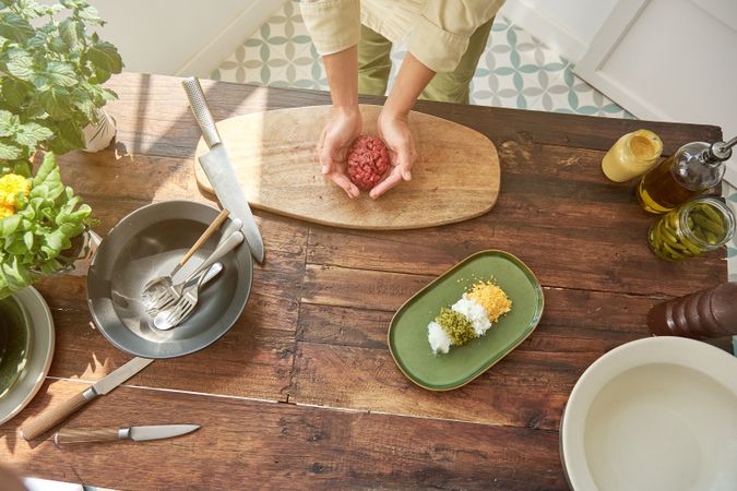 Crop chief cooking steak tartar in kitchen