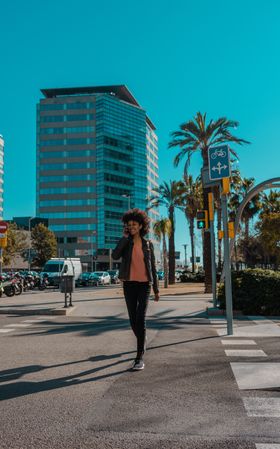 Woman with afro hair walking through the streets