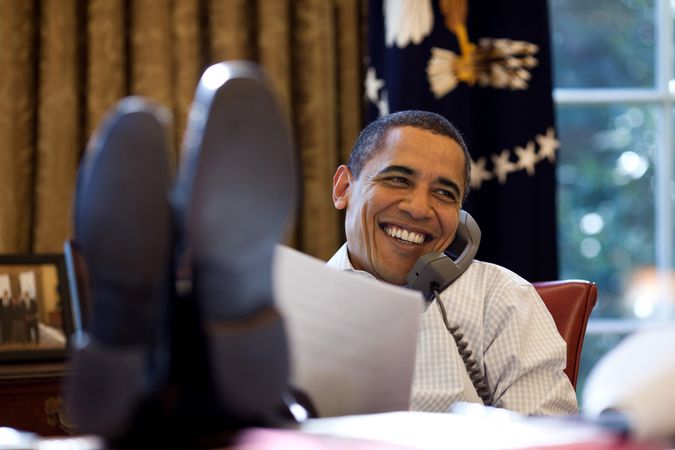 Washington DC, USA -- December 12th, 2009: President Barack Obama smiles while talking with Russian President Dmitry Medvedev on the phone in the Oval Office. Photo by Pete Souza
