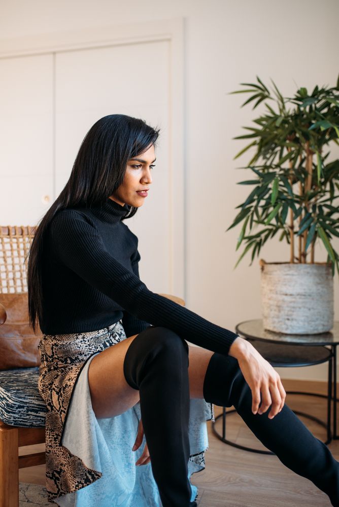 Stylist beautiful young Black woman sitting in a chair