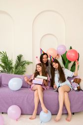 Family, mother and daughters  birthday party with gifts and balloons