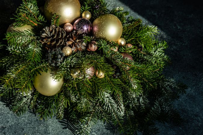 Christmas festive center piece with golden baubles in pine branches