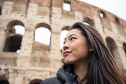 Cheerful Asian traveler outside famous landmark