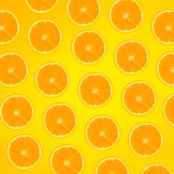 Pattern of orange slices on yellow background