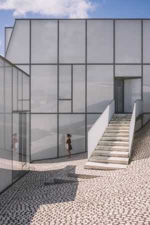 Woman next to contemporary building