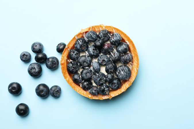 Blueberry pie on blue background, top view