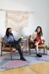 Man and woman addressing the room holding microphones