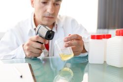 Male assistant using medical device for urine test