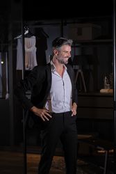 Glad mature businessman standing in dressing room