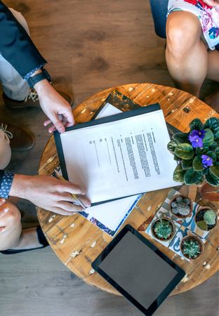 Top view of man ready to sign a document