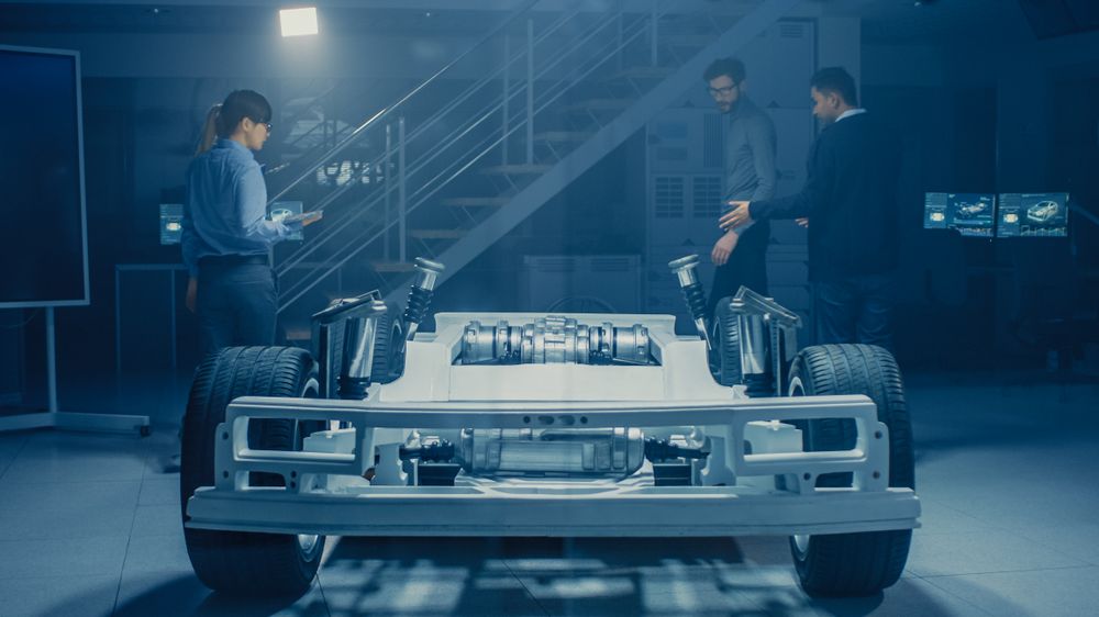 Team of Automobile Design Engineers in Automotive Innovation Facility Working on Electric Car