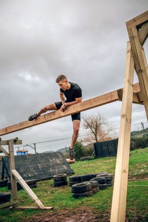 Participant in a obstacle course doing irish table