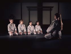 Krav Maga trainer with group of kids in studio