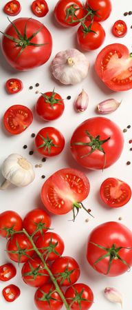 Composition with tomatoes and ingredients on light background, top view